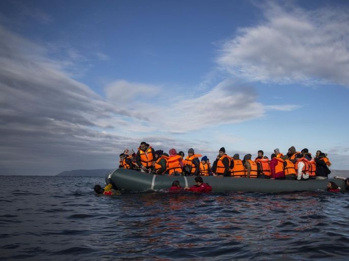 FILE - In this Thursday, Dec. 3, 2015 file photo, refugees and migrants arrive on an inflatable vessel from the Turkish coast to the northeastern Greek island of Lesbos. (AP Photo/Santi Palacios)