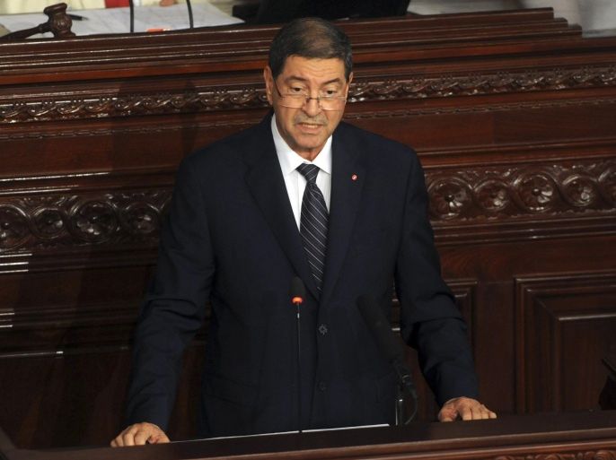 Tunisia's prime minister Habib Essid adresses the parliament in Tunis, Wednesday, July 8, 2015. ays that authorities believe plots aimed at massive deaths and destruction of the country's economy are in the works, and justify the state of emergency declared after a second deadly attack on tourists in three months. (AP Photo/Hassene Dridi)