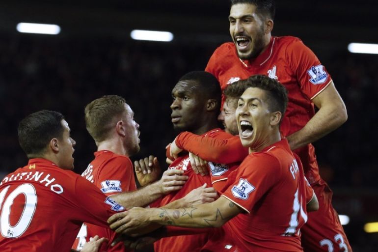 JR710 - Liverpool, Merseyside, UNITED KINGDOM : Liverpool's Zaire-born Belgian striker Christian Benteke (C) celebrates with teammates after scoring the opening goal of during the English Premier League football match between Liverpool and Leicester City at the Anfield stadium in Liverpool, north-west England on December 26, 2015. AFP PHOTO / LINDSEY PARNABY