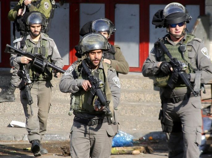 Israeli border policemen check the scence of what the Isreali Army said was a stabbing attempt by a Palestinian women at a military checkpoint in the West Bank city of Hebron, 20 December 2015. No further details were immediately available on any casualties, injureis or arrests.