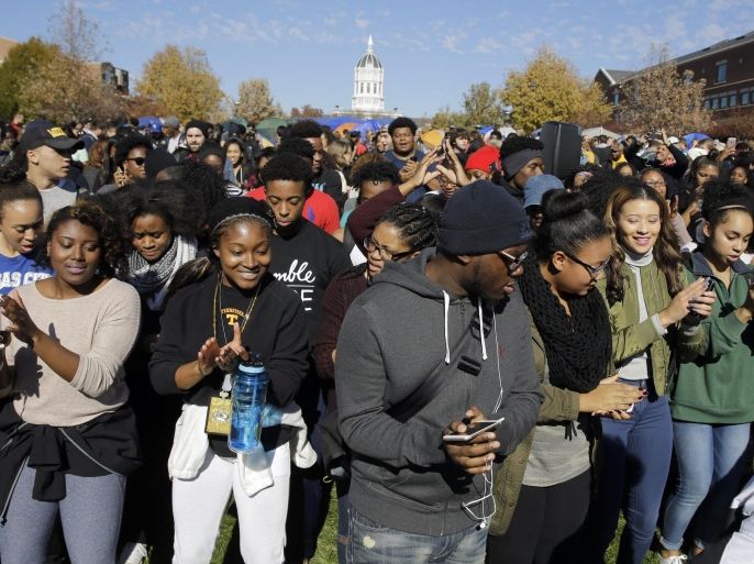 FILE - In this Nov. 9, 2015, file photograph, students dance following University of Missouri System President Tim Wolfe's resignation announcement at the school in Columbia, Mo. The president resigned with the football team and others on campus in open revolt over his handling of racial tensions at the school. University of Missouri turmoil was voted a top story in Missouri in 2015. (AP Photo/Jeff Roberson, File)