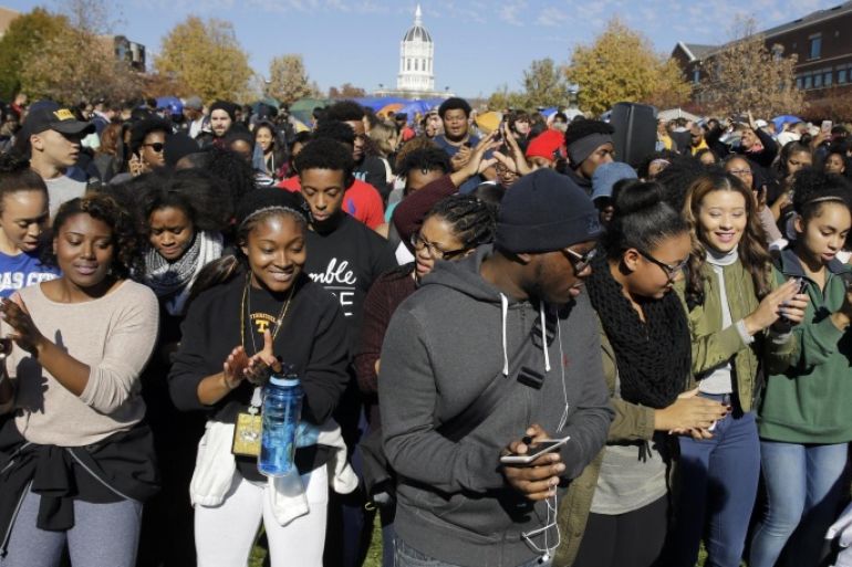 FILE - In this Nov. 9, 2015, file photograph, students dance following University of Missouri System President Tim Wolfe's resignation announcement at the school in Columbia, Mo. The president resigned with the football team and others on campus in open revolt over his handling of racial tensions at the school. University of Missouri turmoil was voted a top story in Missouri in 2015. (AP Photo/Jeff Roberson, File)