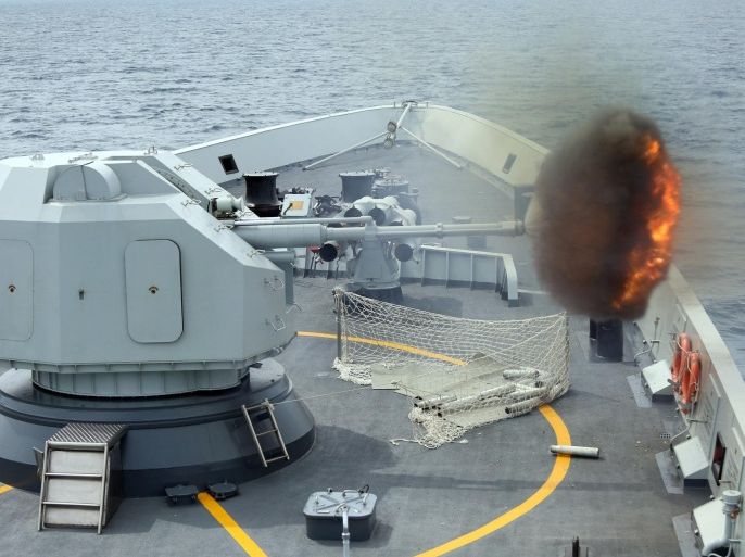 FILE - In this May 24, 2015 file photo released by China's Xinhua News Agency, an anti-surface gunnery is fired from China's Navy missile frigate Yulin during the "Exercise Maritime Cooperation 2015" by Singapore and Chinese navies in the South China Sea. The dispute over the strategic waterways of the South China Sea has intensified, pitting a rising China against its smaller and militarily weaker neighbors who all lay claim to a string of isles, coral reefs and lagoons known as the Spratly and the Paracel islands. China says it is “extremely concerned” with the possibility that the U.S. could start patrolling close to the islands. (Bao Xuelin/Xinua via AP, File) NO SALES