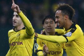Football Soccer - Augsburg v Borussia Dortmund - German Cup (DFB Pokal) - WWK Arena, Augsburg, Germany - 16/12/15 Borussia Dortmund's Borussia Dortmund's Henrikh Mkhitaryan and his team mates Shinji Kagawa and Pierre-Emerick Aubameyang (LtoR) celebrate after he scored a goal against Augsburg. REUTERS/Michaela Rehle DFB RULES PROHIBIT USE IN MMS SERVICES VIA HANDHELD DEVICES UNTIL TWO HOURS AFTER A MATCH AND ANY USAGE ON INTERNET OR ONLINE MEDIA SIMULATING VIDEO FOOTAGE DURING THE MATCH.