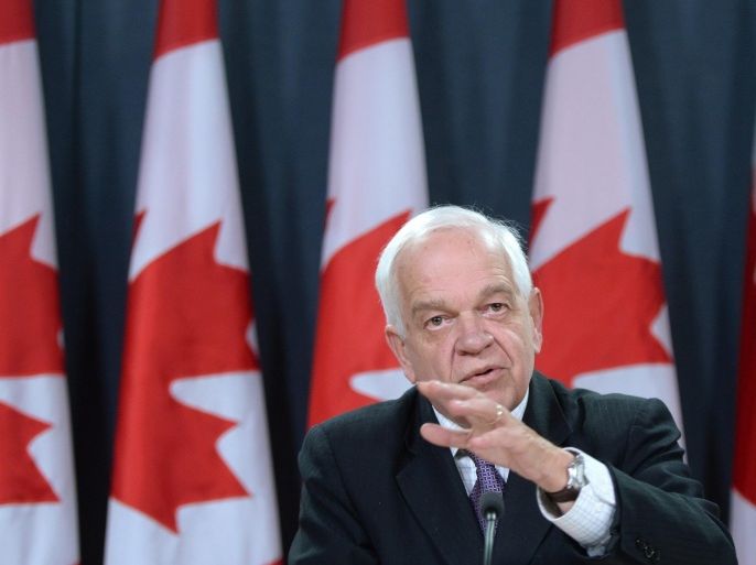 Canada's Minister of Immigration, Refugees and Citizenship John McCallum speaks to media at the National Press Theatre in Ottawa, Ontario on Wednesday, Dec. 9, 2015, regarding Canada’s plan to resettle 25,000 Syrian refugees. (Sean Kilpatrick /The Canadian Press via AP) MANDATORY CREDIT