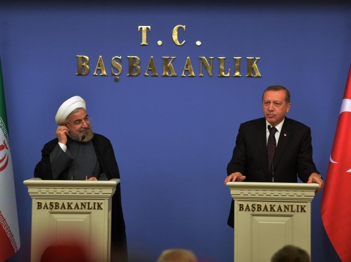 Turkey's Prime Minister Recep Tayyip Erdogan, right, and Iranian President Hassan Rouhani speak to the media after their talks in Ankara, Turkey, Monday, June 9, 2014. Rouhani is in Turkey for a two-day state visit. (AP Photo)