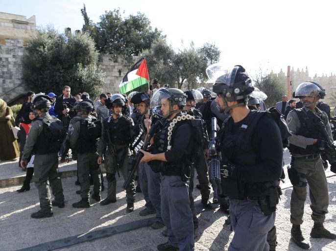 Israeli security forces stand by during a protest by Palestinians just outside Jerusalem's Old City December 26, 2015. Palestinians protested demanding that they be given the bodies of their brethren who have been killed during the latest wave of violence with Israel. REUTERS/Ammar Awad