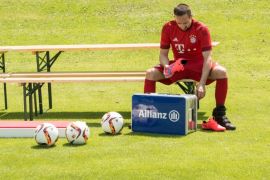 French winger Franck Ribery of German Bundesliga soccer club Bayern Munich puts on his shoes before posing for the team photo in Munich, Germany, 16 July 2015.
