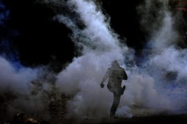 A Palestinian protester kicks a tear gas grenade fired by Israeli soldiers during clashes following a protest against Israeli settlements in Qadomem, Kofr Qadom village, near the the West Bank city of Nablus, 23 October 2015. According to reports, five Palestinians were injured during the clashes. Top diplomats from the United States, Russia, the European Union and the United Nations were set on 23 October to hold talks in Vienna, on the violence gripping Israel and the Palestinian territories, amid fears that a new Palestinian uprising may be in the making.