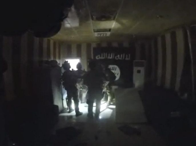 A still image taken from an October 22, 2015 helmet camera video footage shows members of Kurdish counter-terrorism forces and U.S. special forces in a room with Islamic State flag during a raid on a compound in northern Iraq. Kurdish authorities on October 25, 2015 released video of a U.S. and Kurdish special forces raid on an Islamic State compound in northern Iraq. Kurdish counter-terrorism forces planned and led the raid which rescued 69 Kurdish peshmerga fighters early on Thursday, supported by U.S. forces, Iraqi Kurdistan's U.S. representative said. One U.S. commando was killed, the first American to die in ground combat with Islamic State militants. Four Kurds were wounded. REUTERS/Kurdistan Region Security Council via REUTERS TV ATTENTION EDITORS - THIS PICTURE WAS PROVIDED BY A THIRD PARTY. REUTERS IS UNABLE TO INDEPENDENTLY VERIFY THE AUTHENTICITY, CONTENT, LOCATION OR DATE OF THIS IMAGE. EDITORIAL USE ONLY. NOT FOR SALE FOR MARKETING OR ADVERTISING CAMPAIGNS. NO RESALES. NO ARCHIVE. THIS PICTURE IS DISTRIBUTED EXACTLY AS RECEIVED BY REUTERS, AS A SERVICE TO CLIENTS