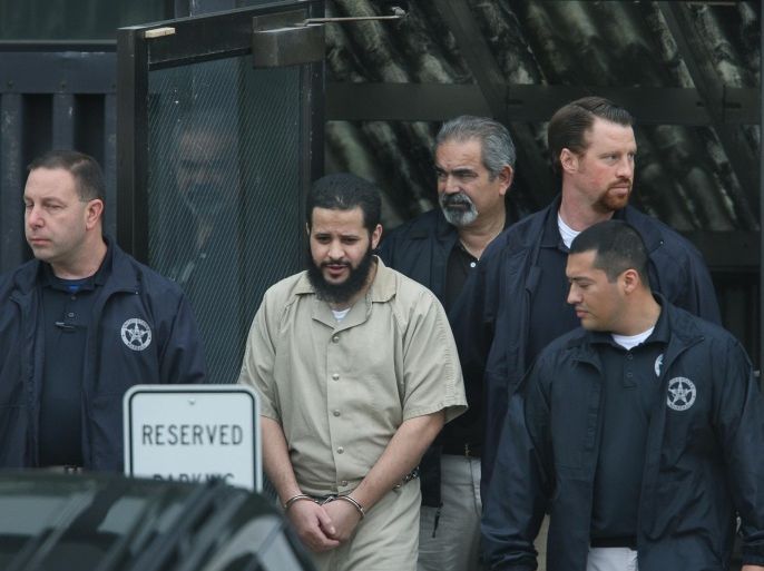 In this Thursday, Sept. 18, 2014 photo, Mufid Elfgeeh is taken out of Federal Court in Rochester, N.Y. Elfgeeh is accused of plotting to kill members of the U.S. military and others pleaded not guilty Thursday to new federal charges that he tried to aid the Islamic State group in Syria and Iraq. With foreign fighters from dozens of nations pouring into the Middle East to join the Islamic State group and other terrorist organizations, U.S. officials are putting new energy into trying to understand what radicalizes people far removed from the fight and into prodding countries around the world to do a better job of keeping them from joining up. (AP Photo/Democrat & Chronicle, Carlos Ortiz) MAGS OUT; NO SALES