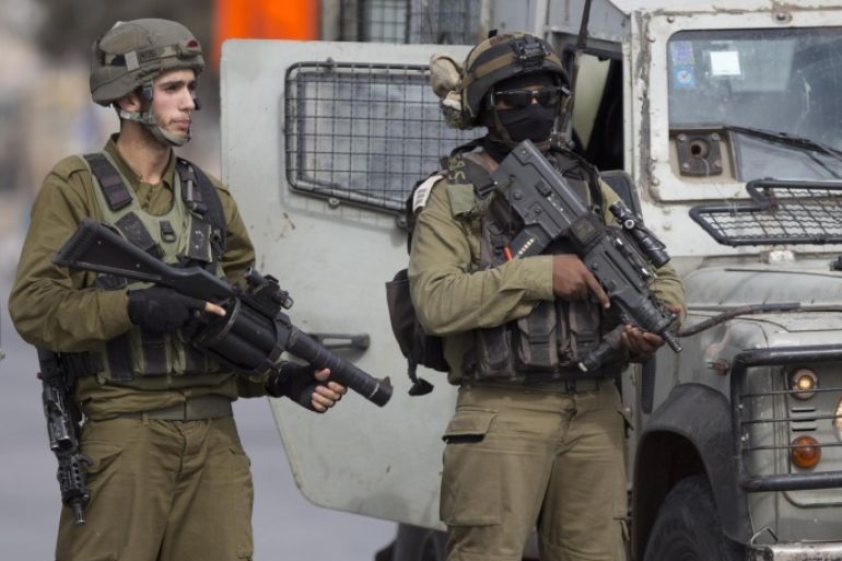 Israeli security forces stand guard as they prevent Palestinians from approaching the area where Palestinian Ahmed Ikmel,16, was killed Saturday after he allegedly attempted to stab an Israeli security guard at the Jalama checkpoint near Jenin, West Bank, Saturday, Oct. 24, 2015. The military said the incident took place at a crossing between Israel and the West Bank. (AP Photo/Majdi Mohammed)
