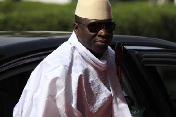 FILE- In this Thursday, Feb. 27, 2014, file photo, Gambia's President Yahya Jammeh arrives for a summit to address a seminar on security during an event marking the centenary of the unification of Nigeria's north and south in Abuja, Nigeria. Heavy gunfire is reported Tuesday Dec. 30, 2014, near the presidential palace in Gambia, according to local residents, raising the specter of a coup attempt while the longtime ruler is currently visiting France, state media reported. On Tuesday, soldiers linked to his presidential guard were believed to be involved in the fighting, according to witnesses who spoke on condition of anonymity for fear of reprisals. (AP Photo/Sunday Alamba, FILE)