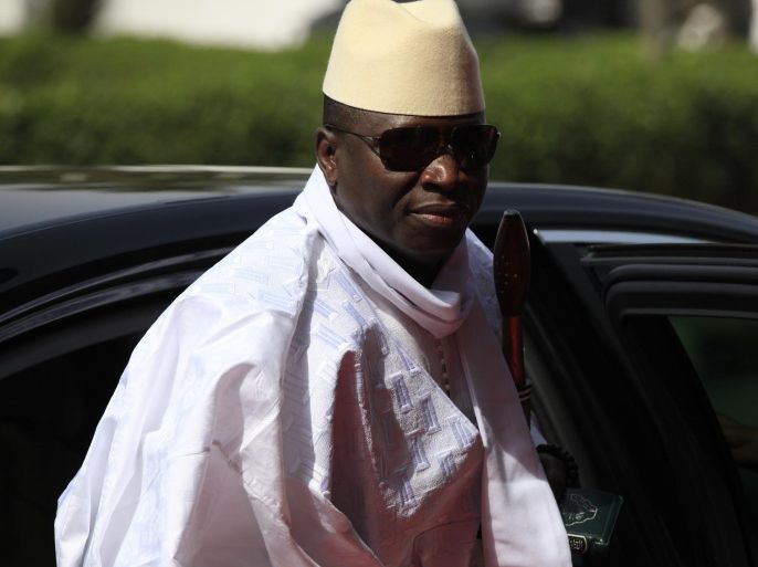 FILE- In this Thursday, Feb. 27, 2014, file photo, Gambia's President Yahya Jammeh arrives for a summit to address a seminar on security during an event marking the centenary of the unification of Nigeria's north and south in Abuja, Nigeria. Heavy gunfire is reported Tuesday Dec. 30, 2014, near the presidential palace in Gambia, according to local residents, raising the specter of a coup attempt while the longtime ruler is currently visiting France, state media reported. On Tuesday, soldiers linked to his presidential guard were believed to be involved in the fighting, according to witnesses who spoke on condition of anonymity for fear of reprisals. (AP Photo/Sunday Alamba, FILE)