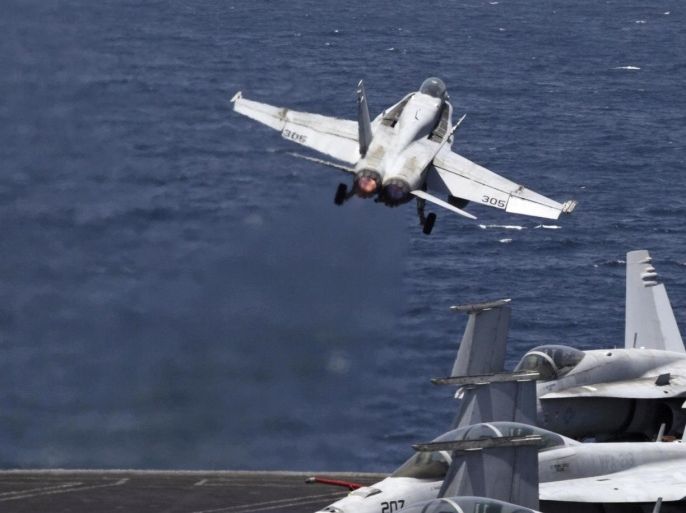 A U.S. F/A-18 fighter jet takes off for Iraq from the flight deck of the U.S. Navy aircraft carrier USS George H.W. Bush in the Persian Gulf, Monday, Aug. 11, 2014. U.S. military officials said American fighter aircraft struck and destroyed several vehicles Sunday that were part of an Islamic State group convoy moving to attack Kurdish forces defending the northeastern Iraqi city of Irbil. (AP Photo/Hasan Jamali)