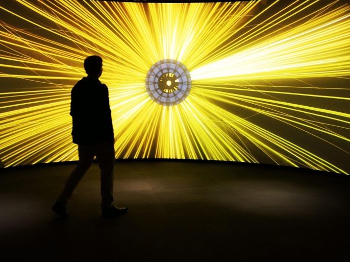 A visitor attends the Large Hadron Collider exhibition at Science Museum in London, Britain, 12 November 2013. The exhibit opens to the public 13 November.