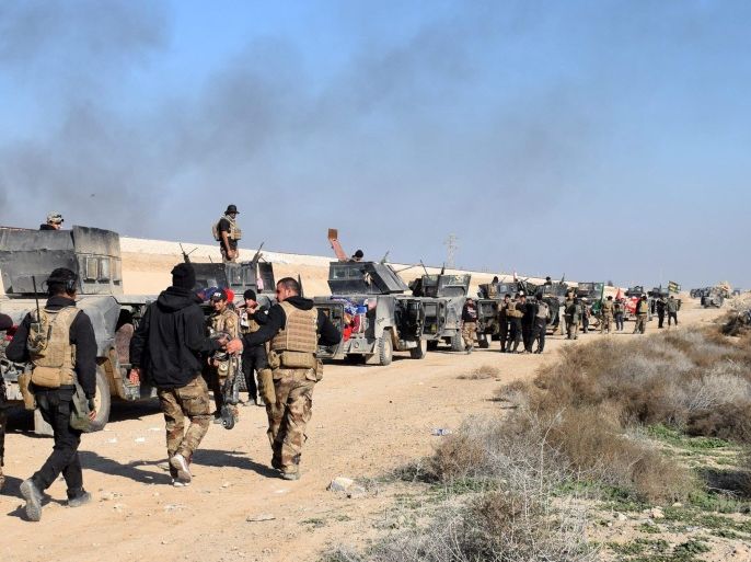 Iraqi military vehicles and troops advance towards the centre of Ramadi city, west of Iraq on 22 December 2015. The Iraqi military forces launched a military operation to retake the provincial capital from IS amid reports IS was preventing civilians from leaving the city. Despite being backed by airstrikes from a US led coalition and estimates between 250 to 300 IS fighters remained in the city.