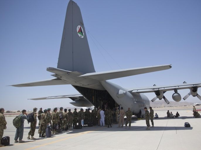 In this Tuesday, Aug. 18, 2015 photo, Afghan National Army soldiers line up to get into a C-130 Hercules, at Kandahar Air Base, in Kandahar, Afghanistan. A series of airports, built by NATO to fight the Taliban, are being handed over to the Afghan government in a civil aviation upgrade that optimists hope will fuel not only regional trade but even tourism. The eight airfields, worth an estimated $2 billion, are scattered around a landlocked and mountainous land whose lack of rail transport or decent roads makes almost every intercity journey a perilous adventure -- even without factoring in attacks from Taliban militants. (AP Photo/Massoud Hossaini)