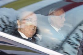 FIFA President Sepp Blatter, left, and his lawyer Lorenz Erni, right, arrive in a car at the FIFA headquarters "Home of FIFA" in Zurich, Switzerland, Thursday morning, Dec. 17, 2015. While FIFA President Joseph S. Blatter will appear in person on Thursday before the panel of four judges of the FIFA ethics court, UEFA President Michel Platini plans to boycott his hearing on Friday 18 December. Blatter and Platini were banned for 90 days for all activities in football. (Walter Bieri/Keystone via AP)