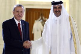 Turkey's President Recep Tayyip Erdogan, left, and Qatar's Emir Tamim bin Hamad Al Thani shake hands during a ceremony in Doha, Qatar, Wednesday, Dec. 2, 2015. Erdogan is on a two-day state visit to the Gulf emirate.(AP Photo/Yasin Bulbul, Presidential Press Service, Pool)