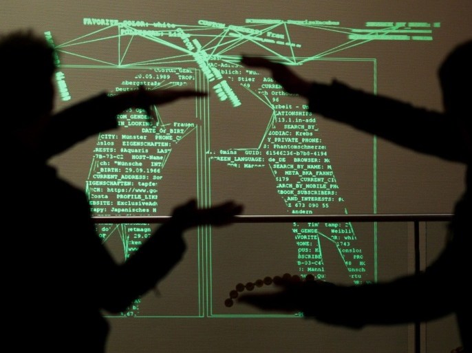 Visitors at the Chaos Computer Club (CCC) congress play with a digital mirror image taken by a camera, which represents the shapes of the players in computer commands, in Hamburg, Germany, 28 December 2015. An estimated 12,000 people are expected to attend the convention of the so-called 'Hacker scene' with themes such as internet security, state survellience and creative IT solutions being on the agenda.