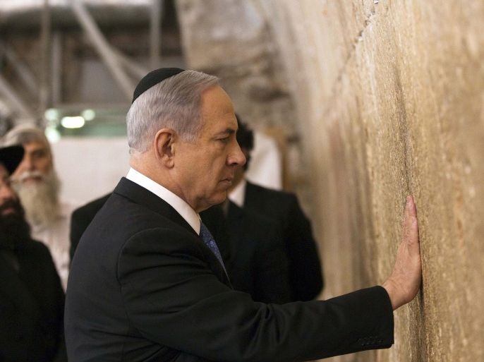 Israel's Prime Minister Benjamin Netanyahu touches the stones of the Western Wall, Judaism's holiest prayer site, in Jerusalem's Old City March 18, 2015. Netanyahu won a come-from-behind victory in Israel's election after tacking hard to the right in the final days of campaigning, including abandoning a commitment to negotiate a Palestinian state. REUTERS/Ronen Zvulun (JERUSALEM - Tags: POLITICS ELECTIONS RELIGION)