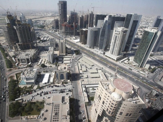 A general view of Doha city with buildings under construction in this December 24, 2012 file photo. The country of just 1.9 million people plans to spend about $140 billion to build stadiums, roads, railways, a new airport, a seaport and other infrastructure before it hosts the 2022 soccer World Cup. Spending on that scale could destabilise a much bigger economy. So recent data showing a sharp rise in inflation is unwelcome - and might, if it becomes a trend, threaten the smooth completion of some of the construction projects. To match Story QATAR-INFLATION/ REUTERS/Fadi Al-Assaad/Files (QATAR - Tags: CITYSCAPE BUSINESS POLITICS CONSTRUCTION)