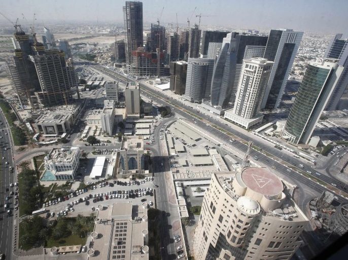A general view of Doha city with buildings under construction in this December 24, 2012 file photo. The country of just 1.9 million people plans to spend about $140 billion to build stadiums, roads, railways, a new airport, a seaport and other infrastructure before it hosts the 2022 soccer World Cup. Spending on that scale could destabilise a much bigger economy. So recent data showing a sharp rise in inflation is unwelcome - and might, if it becomes a trend, threaten the smooth completion of some of the construction projects. To match Story QATAR-INFLATION/ REUTERS/Fadi Al-Assaad/Files (QATAR - Tags: CITYSCAPE BUSINESS POLITICS CONSTRUCTION)