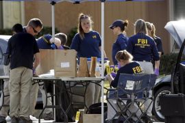 FBI agents gather evidence in front of the Redlands residence and vehicle belonging to the shooters in connection to the Wednesday massacre in San Bernardino, California December 3, 2015. Authorities on Thursday were working to determine why a man and a woman opened fire at a holiday party of his co-workers in Southern California, killing 14 people and wounding 17 in an attack that appeared to have been planned. REUTERS/Alex Gallardo