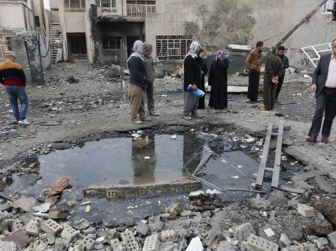 Residents gather at the site of a car bomb blast in New Baghdad, January 12, 2016. REUTERS/Khalid al Mousily