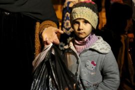 A Syrian girl waits with her family, who say they have received permission from the Syrian government to leave the besieged town, as they depart after an aid convoy entered Madaya, Syria January 11, 2016. An aid convoy entered a besieged Syrian town on Monday where thousands have been trapped without supplies for months and people are reported to have died of starvation. Trucks carrying food and medical supplies reached Madaya near the Lebanese border and began to distribute aid as part of an agreement between warring sides, the United Nations and the Red Cross said. REUTERS/Omar Sanadiki