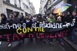 030 - Paris, Paris, FRANCE : Demonstrators march behind a banner reading "high school and college students against the state of energency" during a protest in Paris on January 30, 2016 against government plans to extend a state of emergency for another three months after the November terror attacks in Paris as well as plans to enshrine some of these measures in the constitution. AFP PHOTO / ALAIN JOCARD