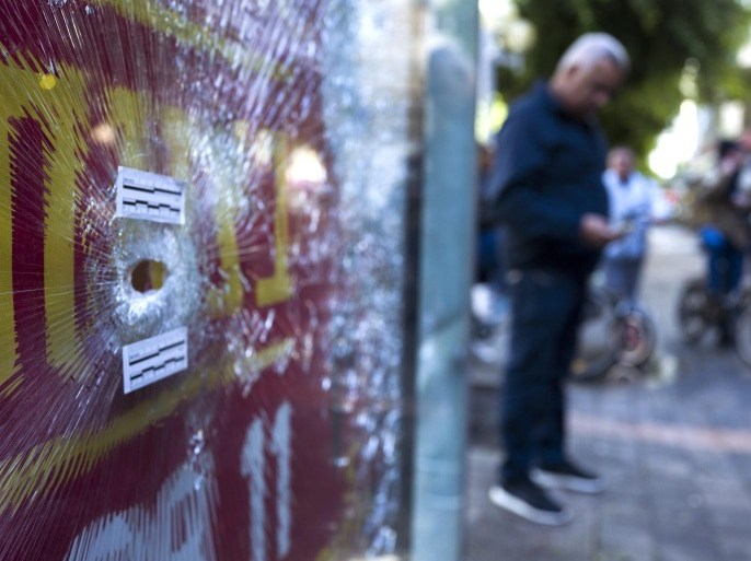 A bullet hole in a bus stops advertising panel in front of the cafe in central Tel Aviv, Israel, 02 January 2016, where an Israeli-Arab man opened fire with an automatic weapon killing two people on 01 January 2016. A man hunt is still underway for the 29-year old suspect who escaped after spraying the cafe with automatic fire. Israeli police widened a manhunt for an Arab-Israeli gunman focusing their searches on greater Tel Aviv and surrounding areas, Israel Radio reported.