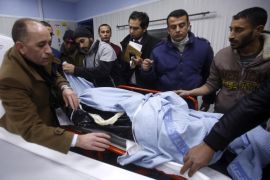 Palestinian mourners amd medics stand around the body of 17-year-old Ahmad Kawazbeh in a hospital in the West Bank city of Hebron, 05 January 2016. Kawazbeh was shot dead by Israeli security forces after he reportedly stabbed and injured an Israeli soldier near a bus station earlier on 05 January, Israeli police said. Since 01 October, Palestinians have launched over 96 knife attacks against Israeli security forces and civilians, killing 20 Israelis, the Israeli Foreign Ministry said recently.
