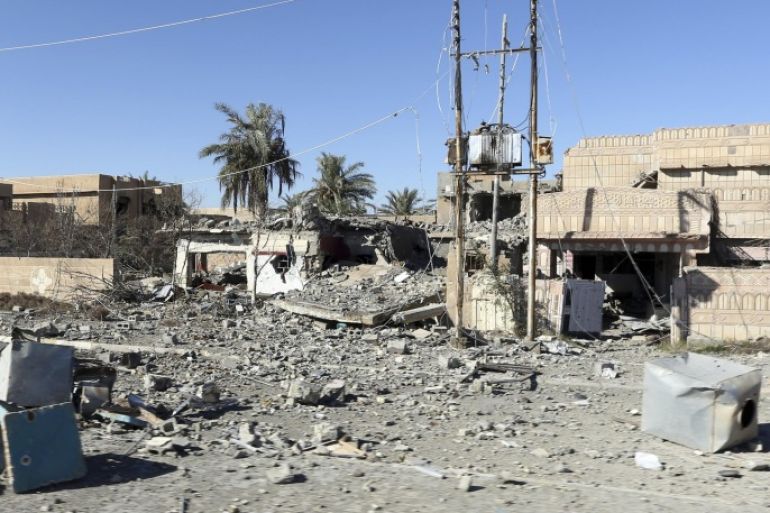 In this Thursday, Jan. 14, 2016 photo, shows destroyed houses in Ramadi, 70 miles (115 kilometers) west of Baghdad, Iraq. Ramadi, once home to 500,000 people, lies largely in ruins after months of air bombardment and the scorched-earth practices of IS fighters in retreat. The U.S-led coalition acknowledges the importance of rebuilding, but actual money for the effort falls far short. (AP Photo/Khalid Mohamme)