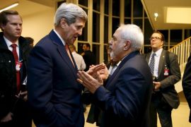 U.S. Secretary of State John Kerry talks with Iranian Foreign Minister Mohammad Javad Zarif after the International Atomic Energy Agency (IAEA) verified that Iran has met all conditions under the nuclear deal, in Vienna January 16, 2016. REUTERS/Kevin Lamarque