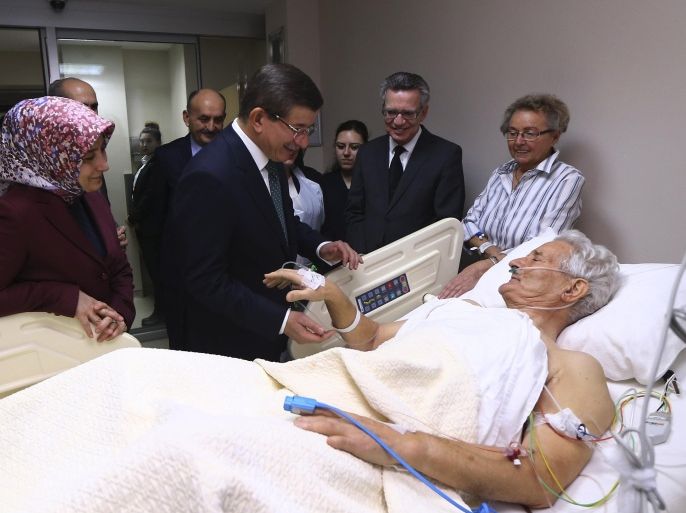 Turkey's Prime Minister Ahmet Davutoglu, center, accompanied by his wife Sare, left, and German Interior Minister Thomas de Maiziere, second right, visit a victim of Tuesday's explosion in the historic Sultanahmet district of Istanbul, at a hospital in Istanbul, Wednesday, Jan. 13, 2016. A suicide bomber detonated a bomb in the heart of Istanbul's historic district on Tuesday, killing 10 foreigners — most of them German tourists — and wounding 15 other people in the latest in a string of attacks by the Islamic extremists targeting Westerners. (Hakan Goktepe/Prime Minister's Press Service, Pool Photo via AP)