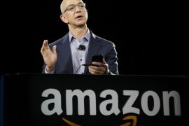 Amazon CEO Jeff Bezos demonstrates the new Amazon Fire Phone, Wednesday, June 18, 2014, in Seattle. (AP Photo/Ted S. Warren)