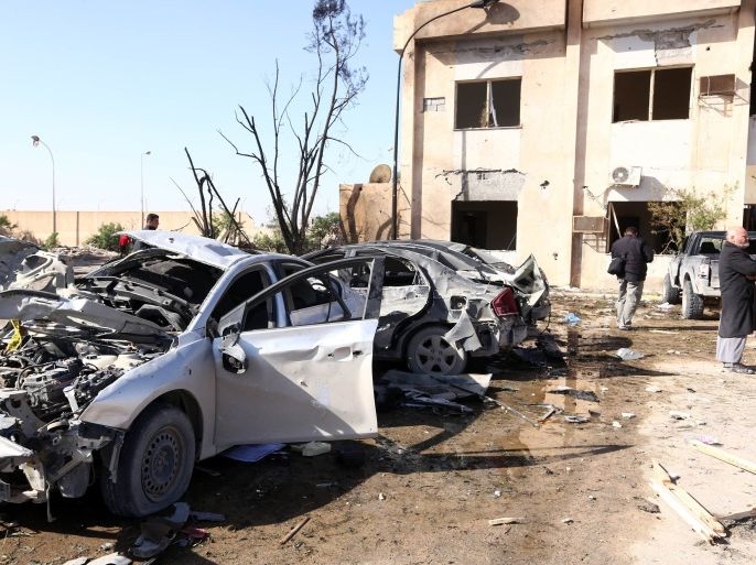 Libyans gather at the site of a suicide truck bombing on a police school in Libya's coastal city of Zliten, some 170 kilometres (100 miles) east of the capital Tripoli, which killed at least 50 people on January 7, 2015, in the deadliest attack to hit the strife-torn country since its 2011 revolution. AFP PHOTO / MAHMUD TURKIA