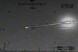 This image made from video released by the U.S. Navy on Saturday, Jan. 9, 2016 shows the view from a Seahawk helicopter in the Strait of Hormuz on Dec. 26, 2015. The U.S. Navy says the video shows a rocket fired from an Iranian Revolutionary Guard vessel near warships and commercial traffic in the strategic strait. What appears to be an oil tanker is seen in the foreground. Previously an Iranian Revolutionary Guard spokesman had denied conducting any naval drills at the time and called the American accusations "psychological warfare." (U.S. Navy via AP)