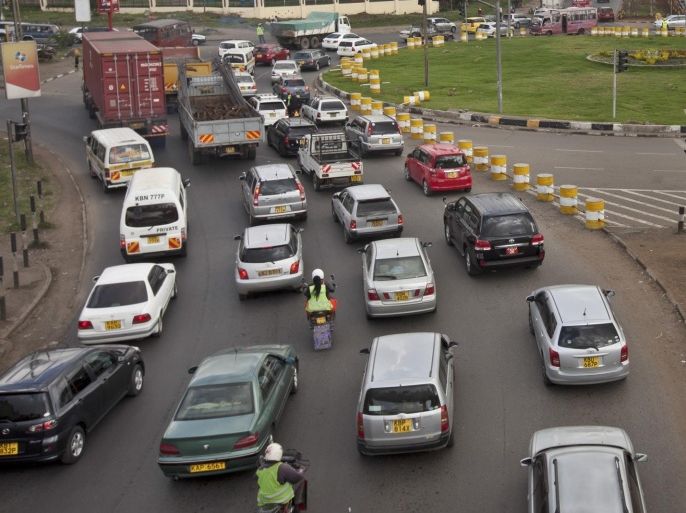Drivers sit in queues of traffic at a traffic circle with its exits blocked off by barriers to prevent right turns, on a highway in downtown Nairobi, Kenya Tuesday, April 14, 2015. A plan launched this month to ease road congestion in Nairobi by replacing key traffic circles with intersections and stoplights has, at least initially, made things worse in some areas with television newscasts filled with cars at a standstill and fuming drivers, some of whom wondered what the gridlock says about leadership and planning in Kenya as a whole. (AP Photo/Sayyid Azim)
