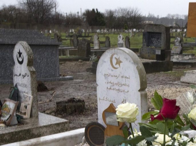 Flowers lay at the grave of slain police officer Ahmed Merabet at the Muslim cemetery of Bobigny, east of Paris, France, Tuesday, Jan. 13, 2015. Merabet, a French Muslim policeman, was one of the victims, killed as he lay wounded on the ground as the gunmen, brothers Said and Cherif Kouachi, made their escape after the killing at Charlie Hebdo newspaper. (AP Photo/Jacques Brinon)