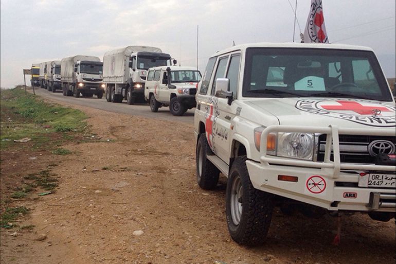 epa05097292 A handout image dated 11 January 2016 made available by the International Committee of the Red Cross, showing a Red Cross aid convoy on its way to the besieged city of Madaya, Syria. A convoy of trucks carrying food and medical aid arrived at a government checkpoint outside the besieged Syrian town of Madaya, where Doctors without Borders (MSF) says almost 30 people have died of starvation. The aid convoy would not cross into Madaya until a parallel convoy was able to enter two government-held Shiite villages besieged by Islamist rebels in north-western Syria. Red Crescent said some 330 tonnes of food and medical aid were being sent to Madaya, enough to last for about 40 days. EPA/HANDOUT BEST QUALITY AVAILABLE HANDOUT EDITORIAL USE ONLY/NO SALES