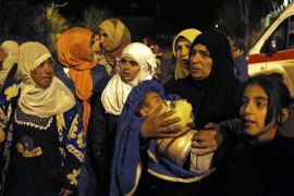 In this Monday, Jan. 11, 2016 photo, people wait to leave the besieged town of Madaya, northwest of Damascus, Syria. Aid convoys reached three besieged villages on Monday — Madaya, near Damascus, where U.N. humanitarian chief Stephen O'Brien said about 400 people need to be evacuated immediately to receive life-saving treatment for medical conditions, malnourishment and starvation, and the Shiite villages of Foua and Kfarya in northern Syria. Reports of starvation and images of emaciated children have raised global concerns and underscored the urgency for new peace talks that the U.N. is hoping to host in Geneva on Jan. 25. (AP Photo)