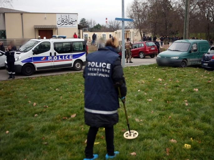A photograp made available on 02 January 2016 showing a French policeman with a metal detector after a man tried to ram the vehicle into French troops protecting a mosque in Valence, in France, on 01 January 2016. Soldiers guarding the mosque in Valence opened fire on the car and the driver, struck by two bullets, is in a serious condition, a spokesman for the local prefecture said. Four soldiers were lightly injured and a bystander received a minor injury to his leg after being hit by a stray bullet.