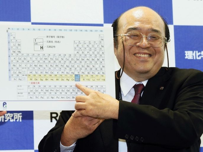 Kosuke Morita of Riken Nishina Center for Accelerator-Based Science points at periodic table of the elements during a press conference in Wako, Saitama prefecture, near Tokyo Thursday, Dec. 31, 2015. A team of Japanese scientists have met the criteria for naming a new element, the synthetic highly radioactive element 113, more than a dozen years after they began working to create it. Morita was notified of the decision on Thursday by the U.S.-based International Union of Pure and Applied Chemistry. (Kyodo News via AP) JAPAN OUT, MANDATORY CREDIT
