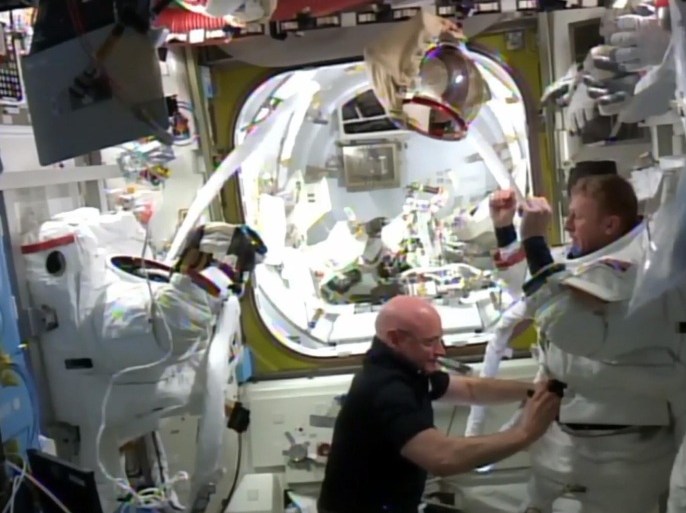 Mission commander Scott Kelly removes the spacesuit of British astronaut Tim Peake (R) after his spacewalk outside the International Space Station was ended early January 15, 2015. Peake became the first astronaut representing Britain to walk in space when he left the International Space Station (ISS) on Friday to fix a power station problem, generating huge interest back in his homeland. REUTERS/NASA/Handout via Reuters FOR EDITORIAL USE ONLY. NOT FOR SALE FOR MARKETING OR ADVERTISING CAMPAIGNS. THIS IMAGE HAS BEEN SUPPLIED BY A THIRD PARTY. IT IS DISTRIBUTED, EXACTLY AS RECEIVED BY REUTERS, AS A SERVICE TO CLIENTS