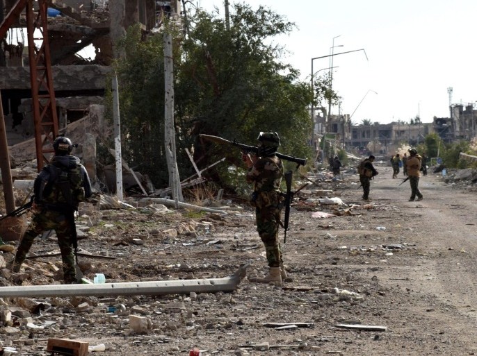 A photograph made available on 07 January 2016 shows Iraqi soldiers patrolling a street in central Ramadi city, western Iraq, 06 January 2016. Last week, Iraqi forces said they had recaptured the provincial capital, Ramadi, in their biggest victory over the Islamic State group in eight months - although some fighting continues around the city.