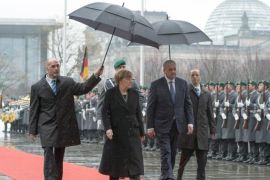 German Chancellor Angela Merkel, second left, and Algeria's Prime Minister Abdelmalek Sellal, second right, review the honor guard during a welcome ceremony in Berlin, Germany, Jan. 12, 2016. (Soeren Stache/dpa via AP)