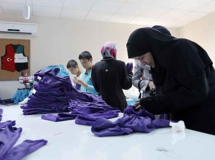 Syrian refugee women and children work in a textile store at Harran Refugee Camp in Sanliurfa, southeast of Turkey, 23 September 2015. Europe is experiencing its most significant influx of migrants and refugees since World War II, with many people fleeing war-torn nations and qualifying for international protection. EU leaders announced plans to redirect 1.7 billion euros (1.9 billion dollars) from the EU budget towards tackling the migration crisis. This includes reallocating as much as 1 billion euros to help Turkey cope with the refugees it has taken in, as well as increasing funding for the World Food Programme, which distributes food in refugee camps near Syria.